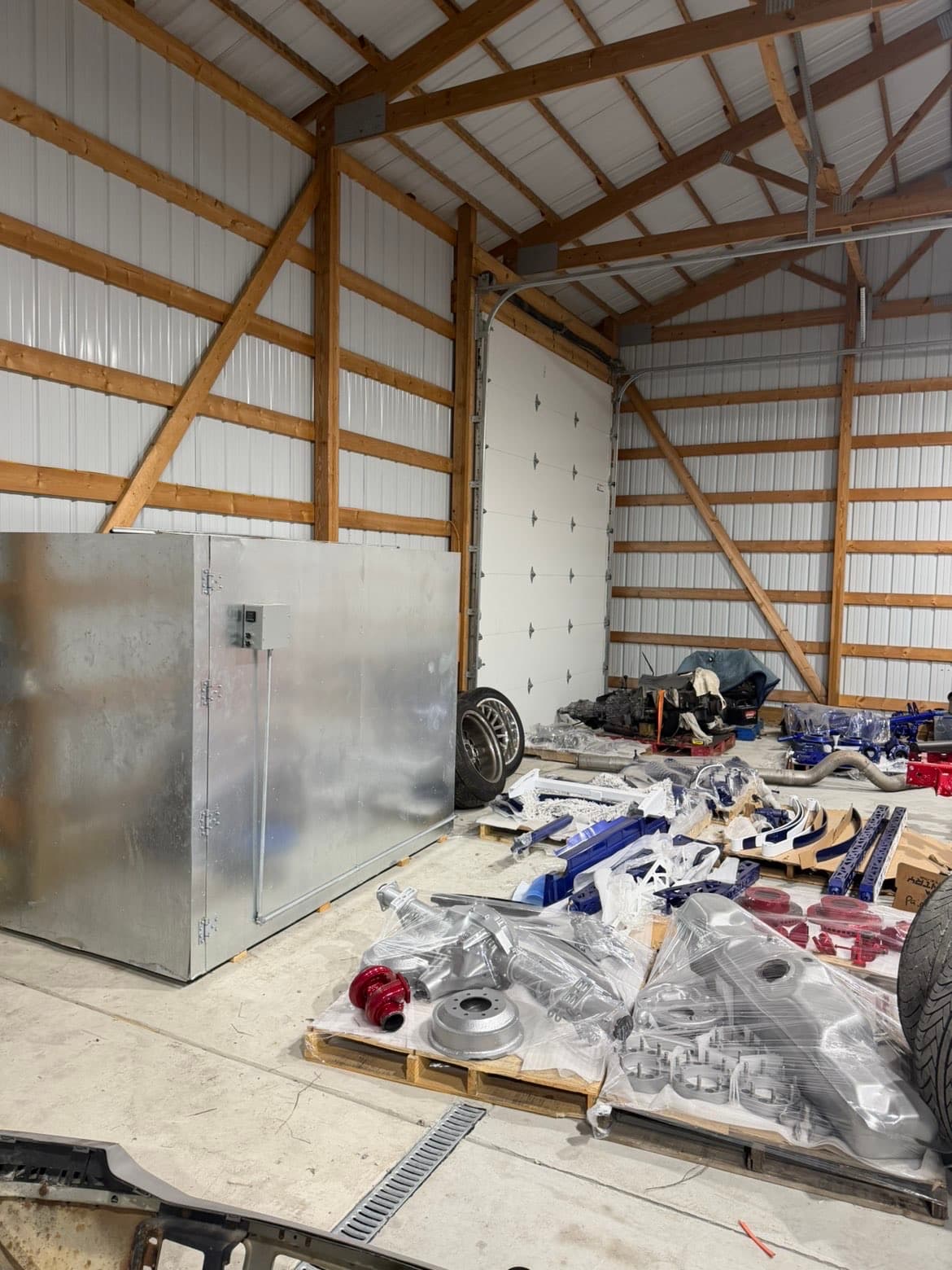 TP Customs LLC shop interior with powder coat oven and suspension parts